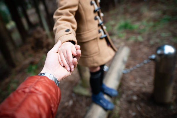 istock Father and daughter hands playing in the park 1206422951