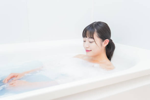 istock Young woman in the bath 1206423200