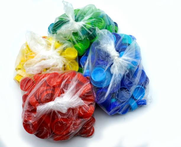 istock Colorful plastic bottle caps sorted by colors in transparent single use plastic bags. PP an PET pollution. 1206423214