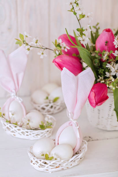 istock Happy easter. Decor and table setting of the Easter table is a vase with pink tulips and dishes of pink and green color. 1206424068