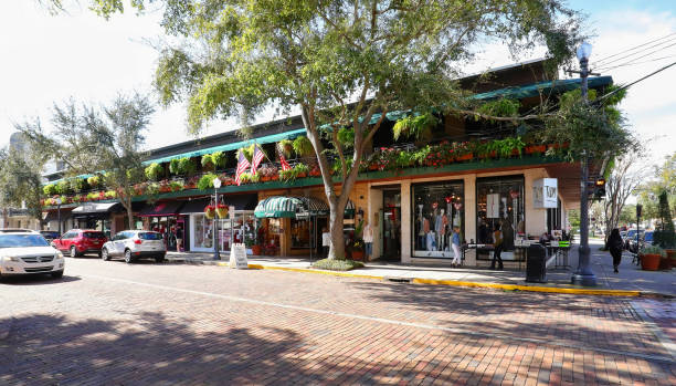 Winter Park downtown street Winter Park, Florida, USA - January 26, 2020:  Retail stores on South Park Avenue in downtown Winter Park.  Famous for it's upscale shopping and world class museums. winter park florida stock pictures, royalty-free photos & images