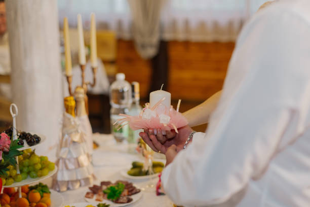 istock Beautiful newlyweds light a candle at a wedding celebration 1206424430