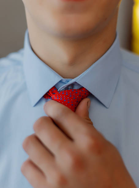 istock A young man puts on a tie. Businessman 1206424560