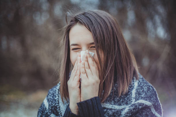 istock girl blowing her nose 1206424624