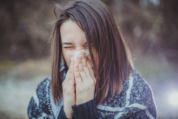 istock girl blowing her nose 1206424644