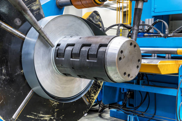 istock Industrial metal sheet coils connected with metal sheet profile forming machine. 1206424721