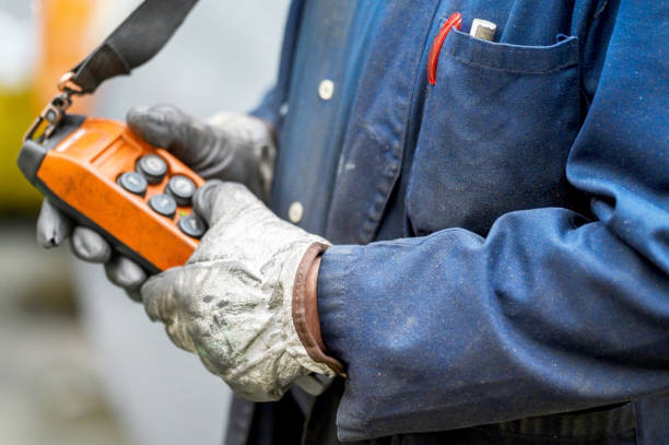istock Male hand push remote control switch for overhead crane in the factory, close-up. Electrical control panel of the crane and other lifting equipment in laborer hand. 1206425426