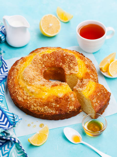 istock Lemon bundt cake with cup of tea. Blue background. Close up. 1206425800