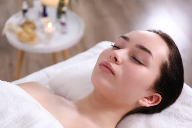 istock Brunette female with relaxed facial expression lying on a massage table. 1206426561