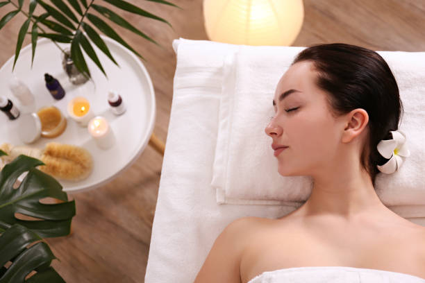 istock Brunette female with relaxed facial expression lying on a massage table. 1206426971