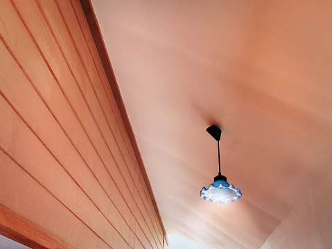 Low Angle View of Illuminated Lamp Hanging Under Ceiling