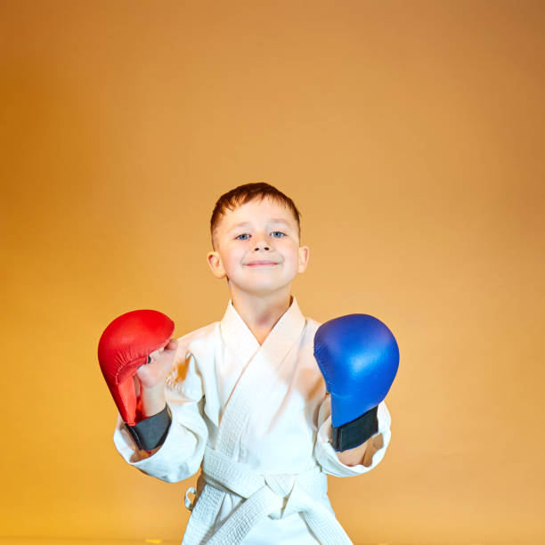 istock On an orange background, an athlete with red and blue overlays on his hands 1206429802