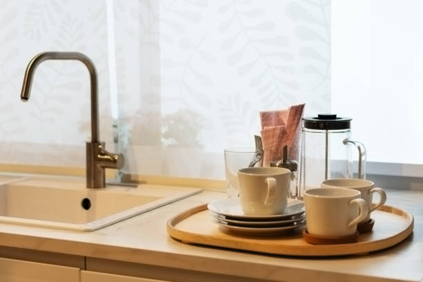 istock Clean utensils on wooden table near kitchen sink. 1206429817
