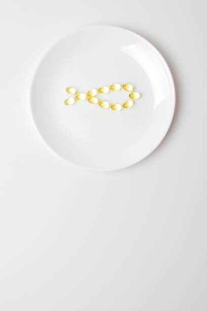 istock Fish oil softgels on a white background in a shape of a fish 1206429910