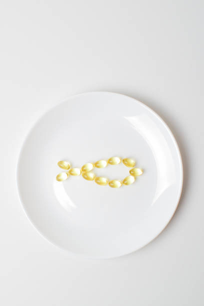 istock Fish oil softgels on a white background in a shape of a fish 1206429924