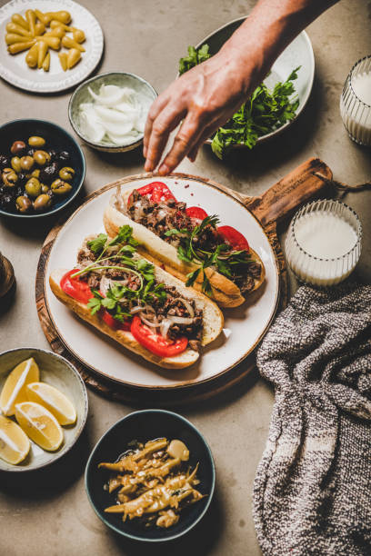istock Mans hand over Turkish traditional meat sandwich tantuni 1206433671