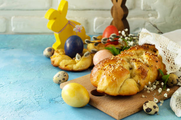 istock Easter sweet bread with colored eggs and traditional Italian Easter bread ringson a blue stone concrete tabletop. Copy space. 1206436834