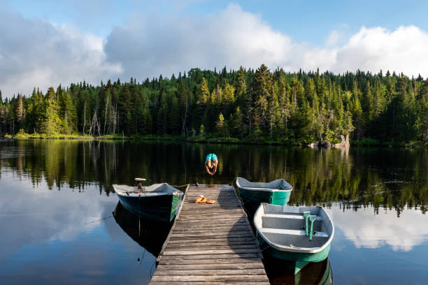 istock Man diving in a lake at sunrise. 1206437698