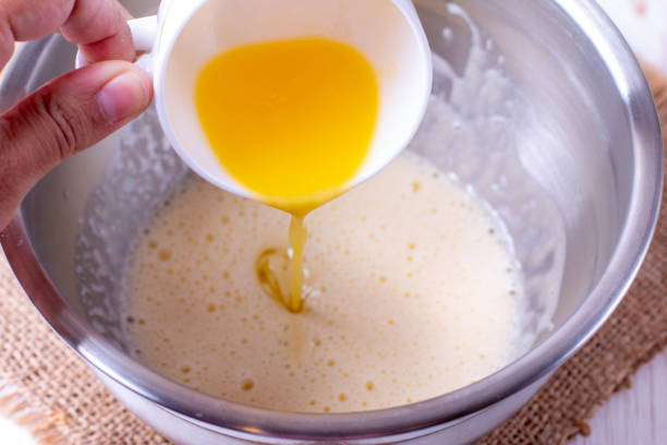 istock Pour the butter into the dough 1206442569
