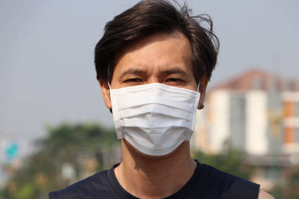 istock Masked Asian man prevent germs. concept of Tiny Particle or virus protection. 1206447398