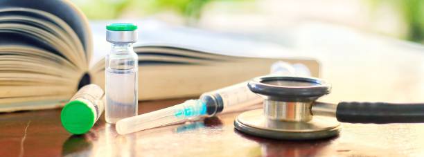 Vaccine Rabies Bottle and Syringe Needle Hypodermic Injection,Immunization rabies and Dog Animal Diseases,Medical Concept with Dog blurred Background.Selective Focus Vaccine vial stock photo stock photo