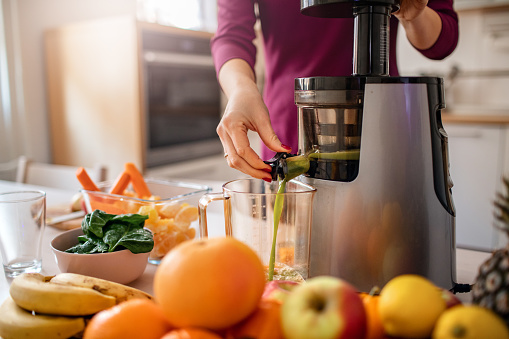 Preparing cold pressed juice in the kitchen.