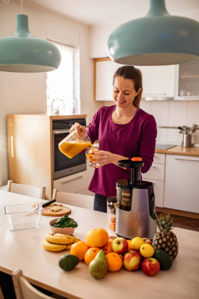 istock Woman Preparing Cold Pressed Juice 1206448704