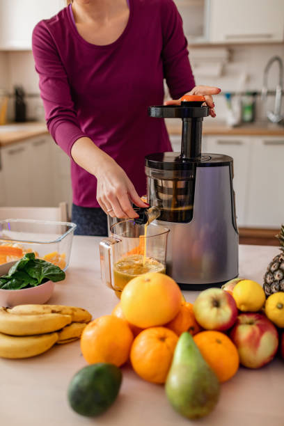 istock Woman Preparing Cold Pressed Juice 1206448716