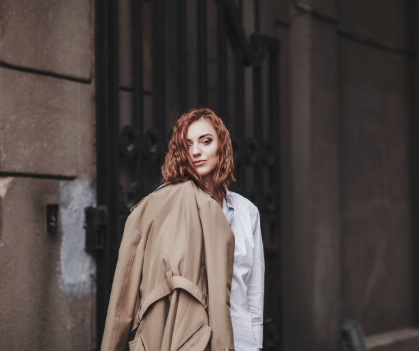 istock woman holding a coat in her hands 1206448947
