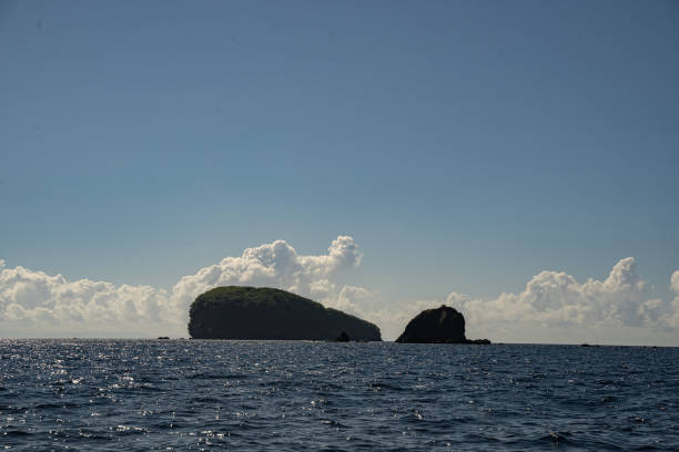 istock Glittering sea with mountains hills and clouds 1206450083