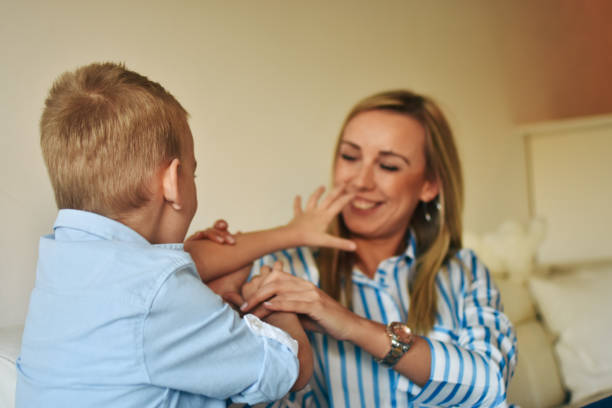 istock Happy mom plays with her son at home 1206450355