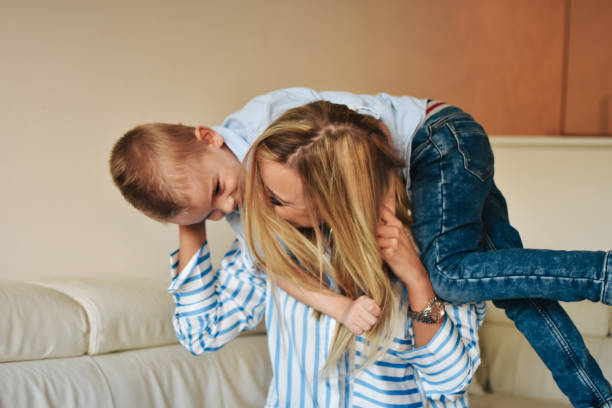 istock Happy mom plays with her son at home 1206450707
