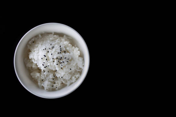 istock Japanese cooked rice in a white bowl on black table. 1206452000