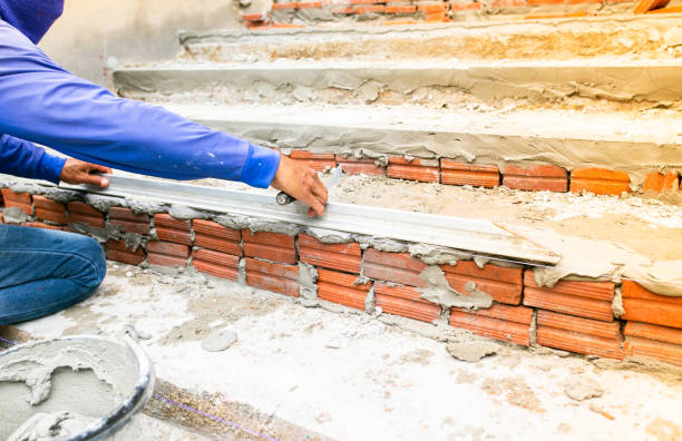 istock Worker labor, Mixer operator building staircase with concrete cement and brick at construction site. 1206453013