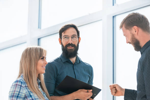 istock business colleagues discussing the document in the office lobby 1206453177