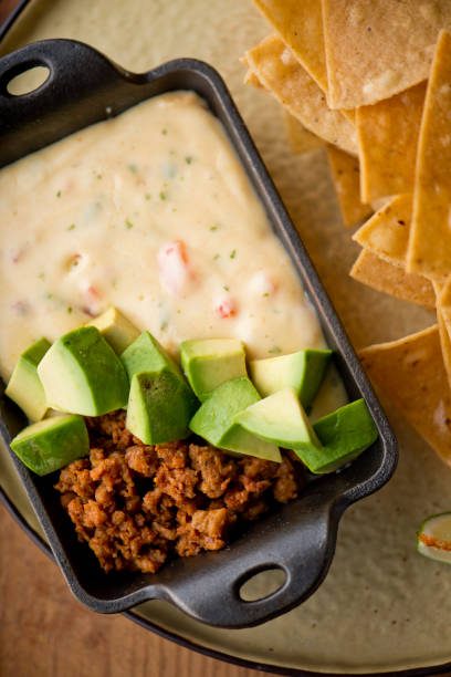 istock Queso cheese dip. Traditional classic Tex-Mex/Mexican restaurant appetizer favorite. Queso dip melted cheeses mixed with spices and hot sauce. Served with homemade tortilla chips avocado & meat 1206453278
