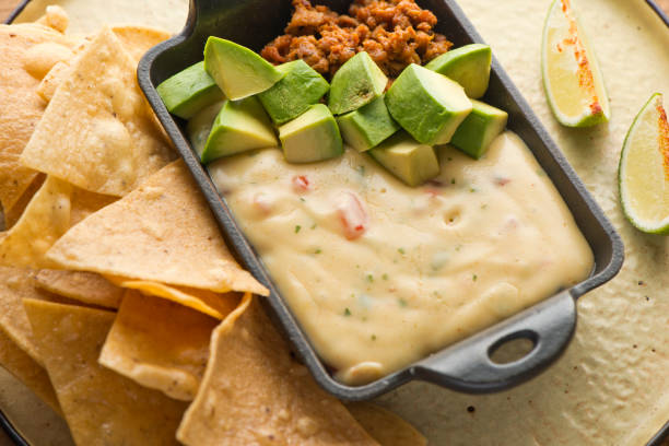 istock Queso cheese dip. Traditional classic Tex-Mex/Mexican restaurant appetizer favorite. Queso dip melted cheeses mixed with spices and hot sauce. Served with homemade tortilla chips avocado & meat 1206453284