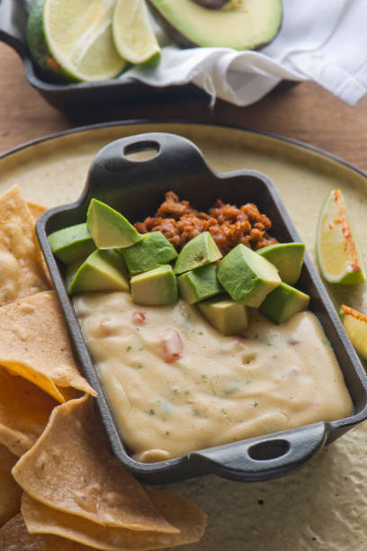istock Queso cheese dip. Traditional classic Tex-Mex/Mexican restaurant appetizer favorite. Queso dip melted cheeses mixed with spices and hot sauce. Served with homemade tortilla chips avocado & meat 1206453306