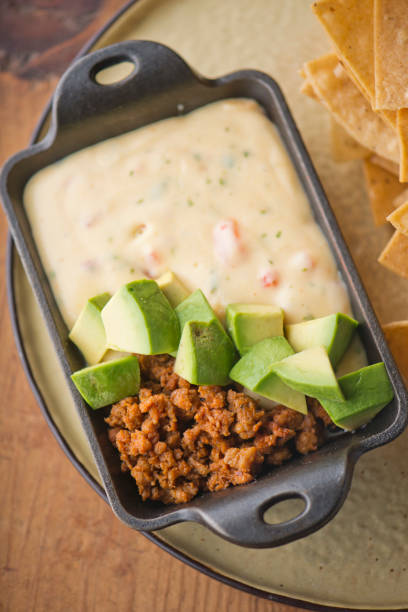 istock Queso cheese dip. Traditional classic Tex-Mex/Mexican restaurant appetizer favorite. Queso dip melted cheeses mixed with spices and hot sauce. Served with homemade tortilla chips avocado & meat 1206453309