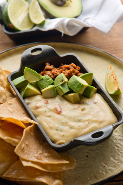 istock Queso cheese dip. Traditional classic Tex-Mex/Mexican restaurant appetizer favorite. Queso dip melted cheeses mixed with spices and hot sauce. Served with homemade tortilla chips avocado & meat 1206453312