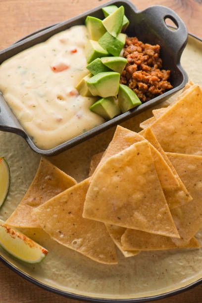 istock Queso cheese dip. Traditional classic Tex-Mex/Mexican restaurant appetizer favorite. Queso dip melted cheeses mixed with spices and hot sauce. Served with homemade tortilla chips avocado & meat 1206453322