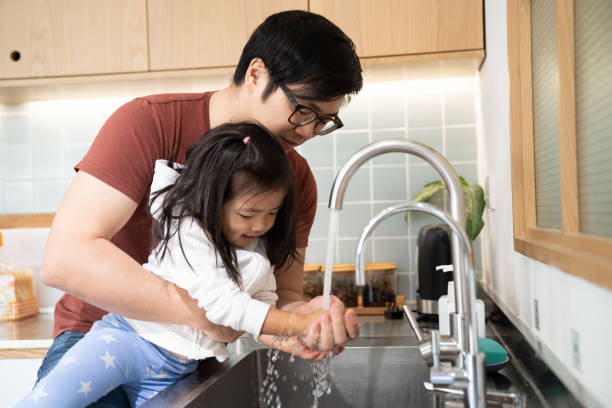 istock A father teaches his daughter to wash hands 1206458985