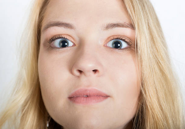 istock young pretty woman blue eyes close up. surprised expression. large round bulging eyes 1206460062