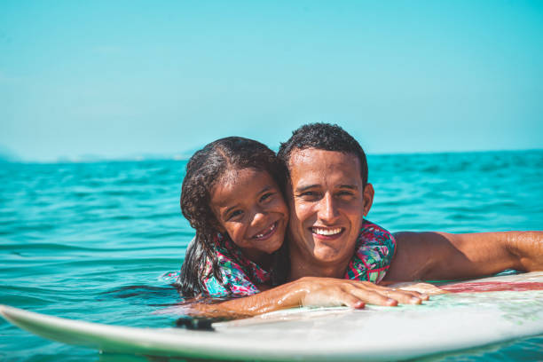 istock Father and daughter surf day 1206460883