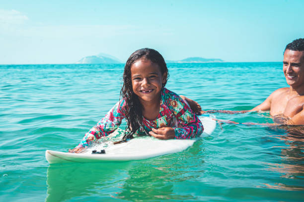 istock Girl is lying on the surfboard 1206460991
