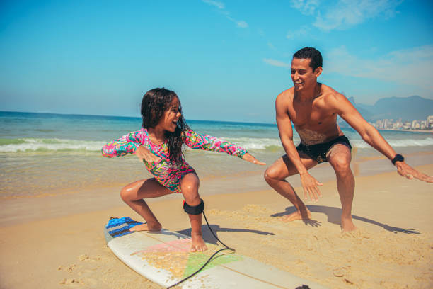 istock Father and daughter surf day 1206461220