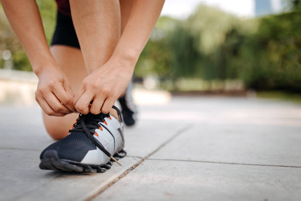istock Woman tying shoelace in the public park 1206461237