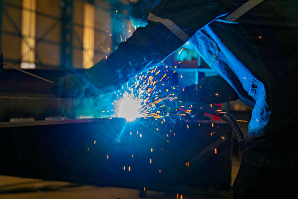istock Industrial worker man welding in a factory. 1206463549