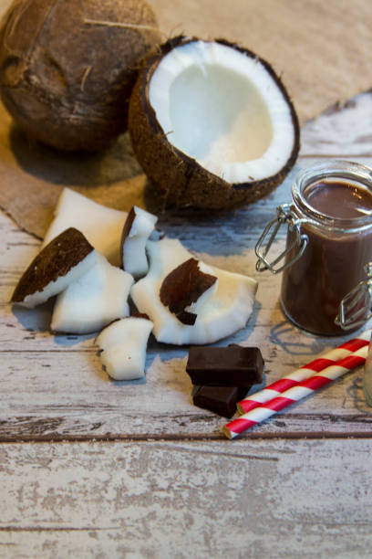 istock Chocolate milk protein shake with colored striped straw and coconut 1206464621
