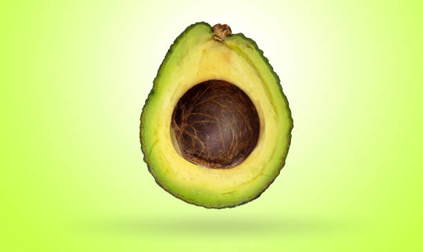 istock Avocado cut in half isolated on gradients green and white background with clipping path 1206464873